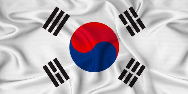 South Korean flag with red and blue yin-yang and black trigrams on white background.