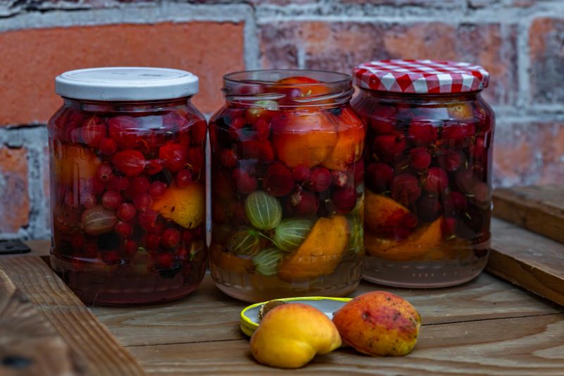 Fruit mix compote on wooden box near red brick old wall
