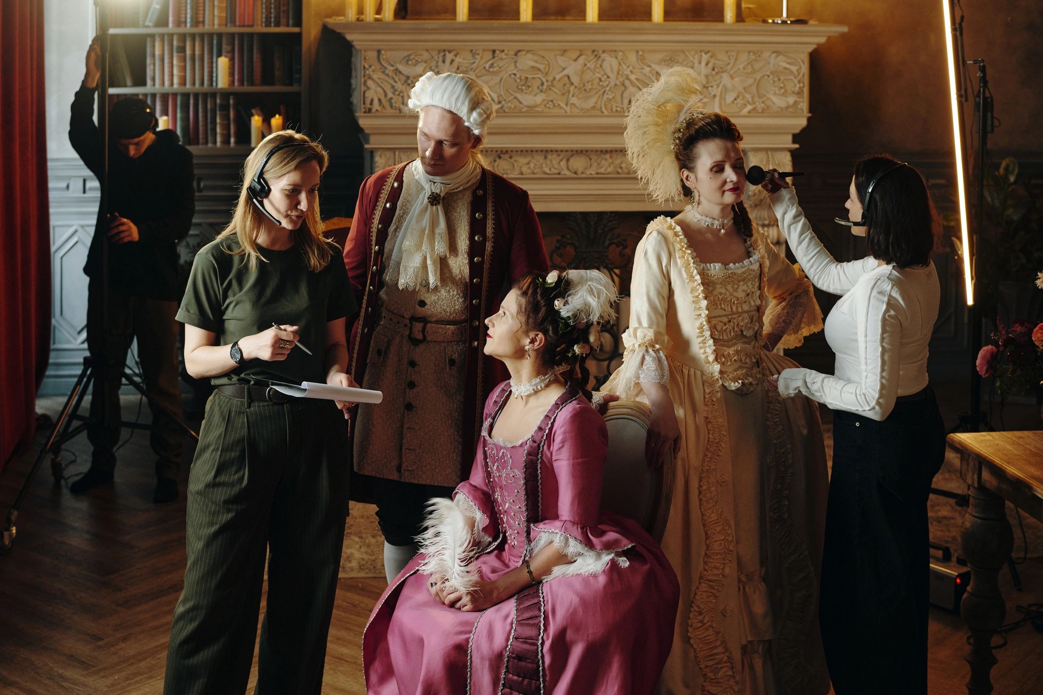 in-between takes on a film set of a period drama with actors in costume and film crew