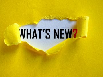 A torn yellow paper reveals the text "WHAT'S NEW?".