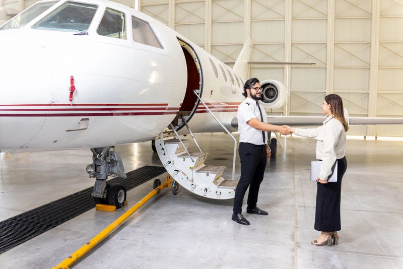 Pilot welcoming his first-class passenger on an executive jet