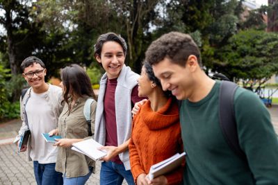 Group of young students walking together outdoors.