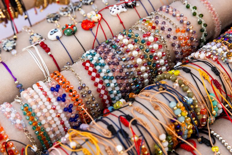 Gift Shop of Baku old town assortment. Colorful handmade beaded bracelets arranged on a fabric display. Vibrant designs and intricate patterns showcase artisanal craftsmanship