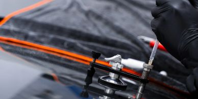Close-up of a technician injecting fluid with a syringe.