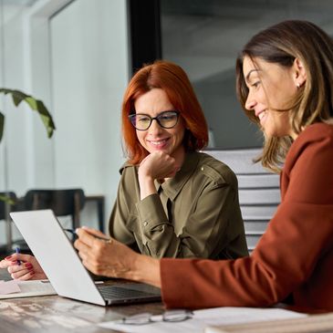 two colleagues looking at a laptop screen