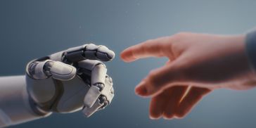 A robotic and human hand reaching towards each other.