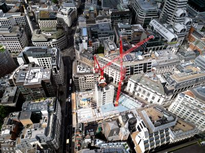 Aerial view of a city with a construction site and crane.