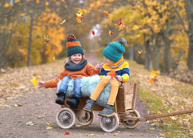 Autumn Bliss: Laughing Children Amid Vibrant Fall Colors