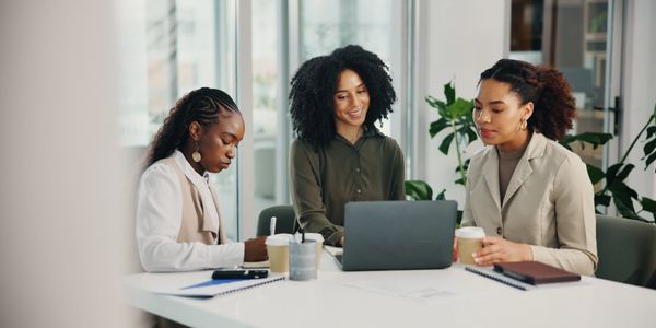 3 black women working in a conference room