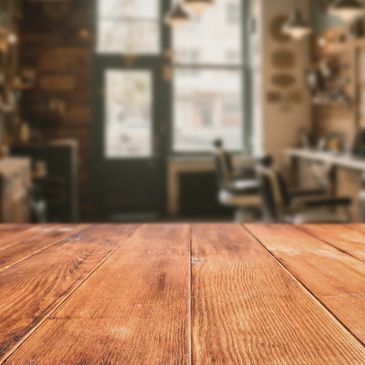 Wooden table in a cozy, softly lit room with blurred background.