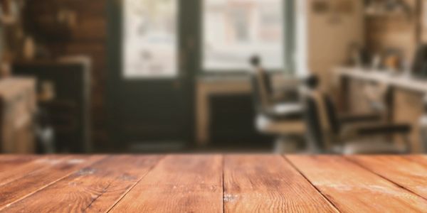 Empty wooden table with blurred cafe interior background.
