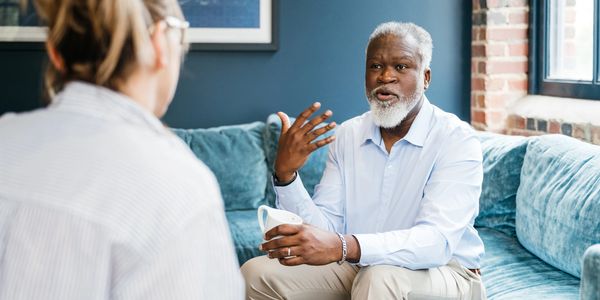 Therapist speaking with client during anxiety therapy session.