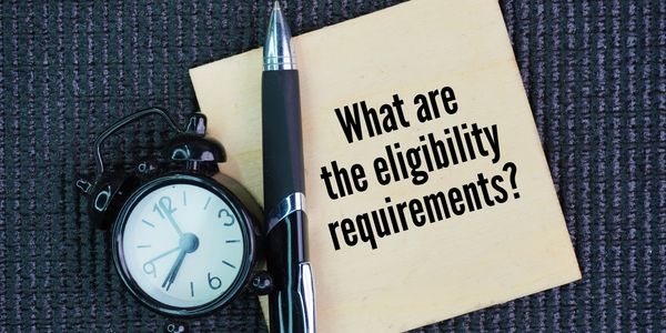 A note asking about eligibility requirements with a clock and pen.