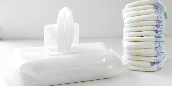 Baby wipes pack and folded diapers.