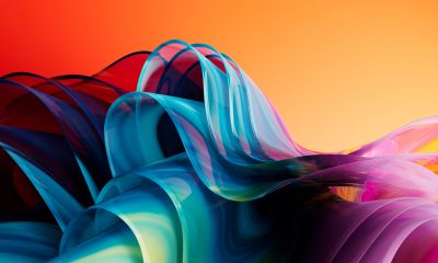 Abstract colorful waves flow against an orange gradient background.