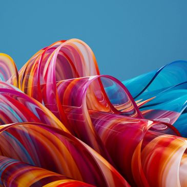 Colorful abstract glass waves against a blue background.