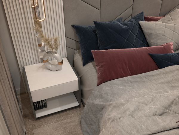Modern bedroom with a white nightstand and decorative vase.