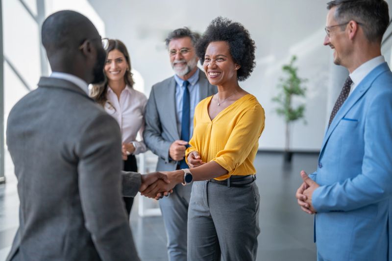 Business team shaking hands in agreement in the office hall