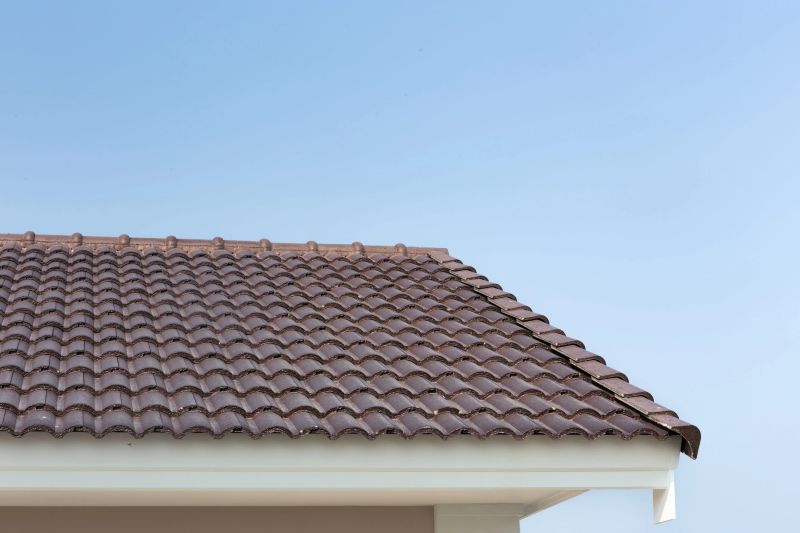 Roof tiles of house building. Terracotta material in reddish brown color with interlocking pattern, modern contemporary style. Ideal for construction, roofing and residential property presentation.