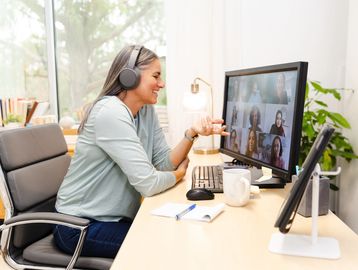 Woman smiling during video call at home.
