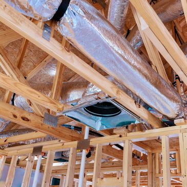 Ductwork and wooden framing in a building under construction.