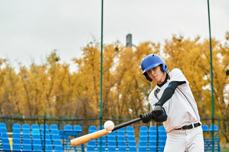A talented baseball player focuses on his swing while playing baseball during practice in fall.