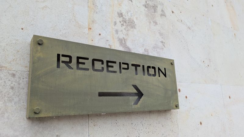 A visible reception sign that indicates direction, making it ideal for hospitality and directional signage