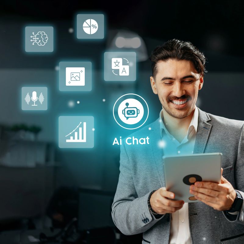 A young professional stands in a sleek office space, holding a tablet while smiling. Digital icons representing AI tools and data visualization surround him, highlighting a tech-savvy atmosphere.