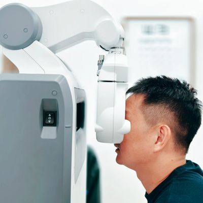Man undergoing an eye examination with medical equipment.