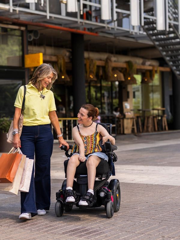 Disability support worker with an NDIS participant out in the community