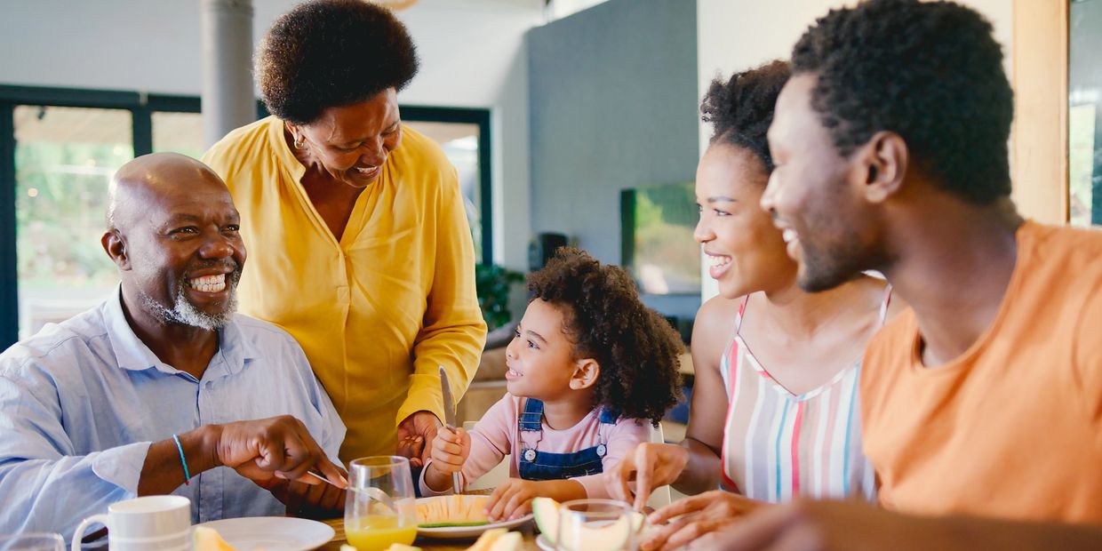 Three generations of a family sharing a meal at home