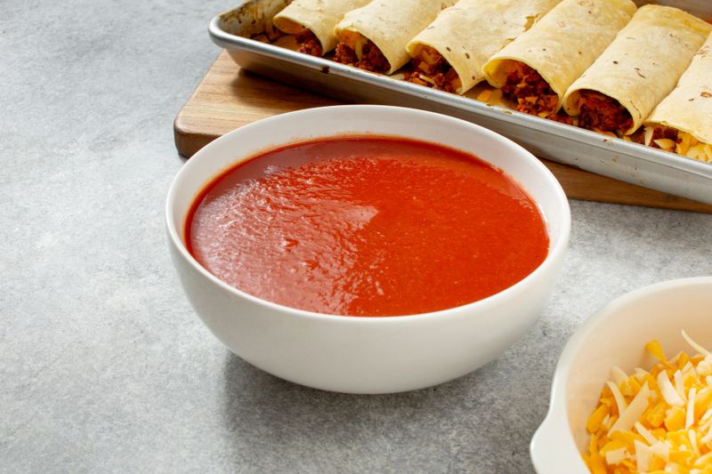 A view of a bowl of enchilada sauce.