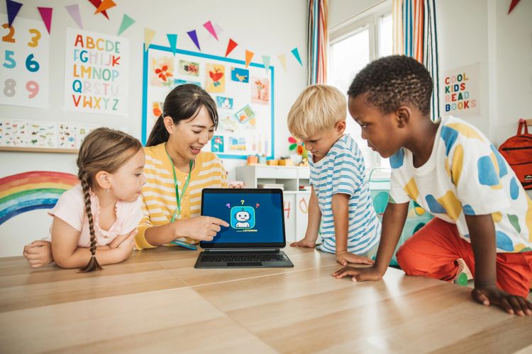 Stack of books next to pencils in a holder and a camera.