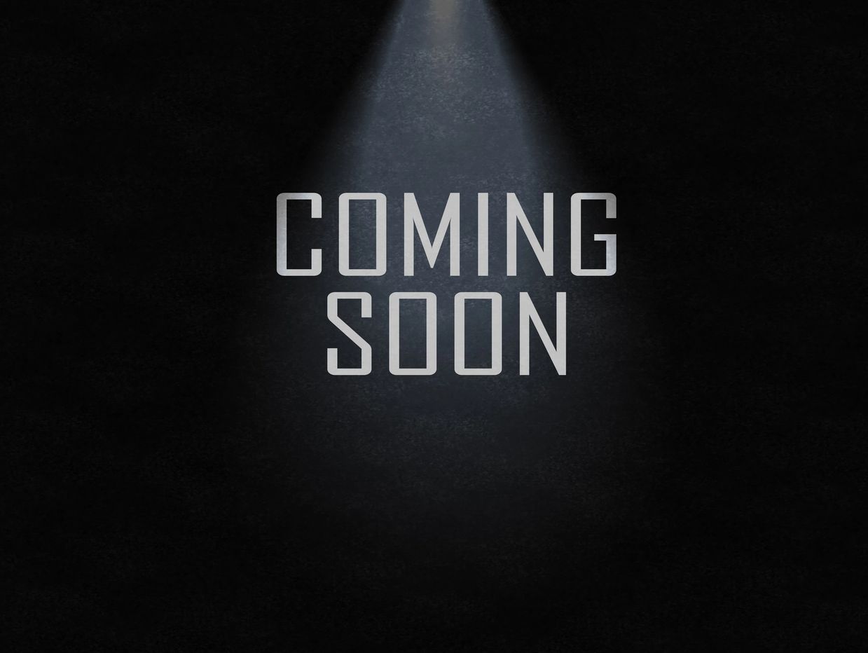 Text saying coming soon under a spotlight.