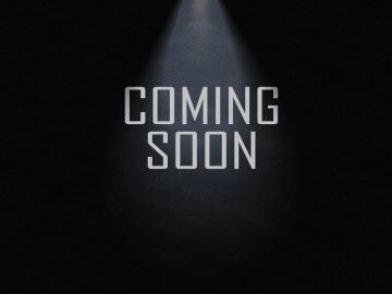 Tekst 'Coming Soon' verlicht door een spotlicht.