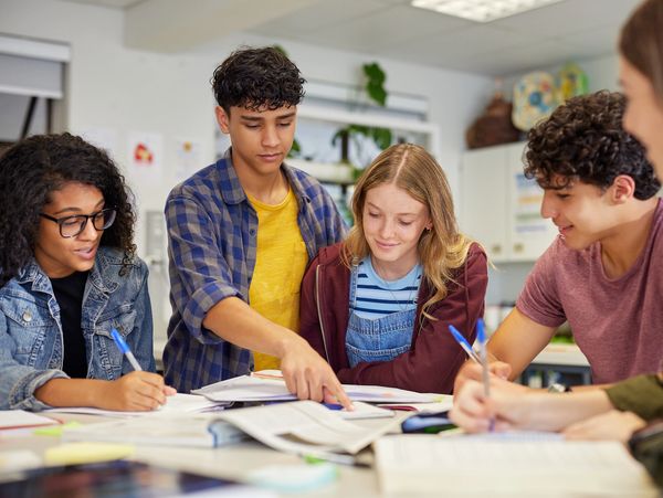 Group of students studying together and discussing.