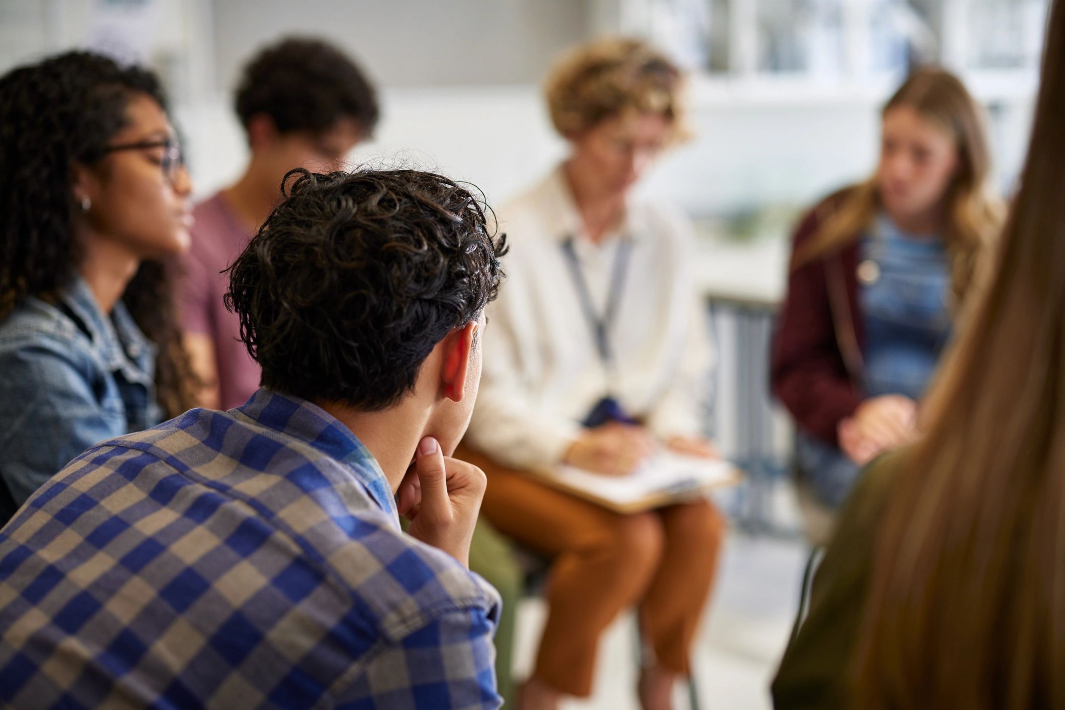 A group of adults engaged in group therapy
