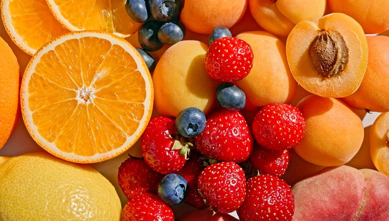 various colorful bright fresh fruits background, top view