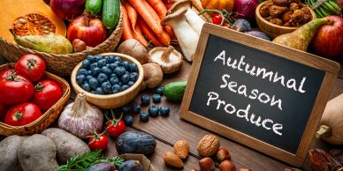 Autumnal season produce displayed with chalkboard sign.