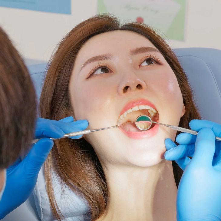 Dental professional examining a patient during a consultation