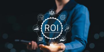Person holding virtual ROI graphic with business icons.