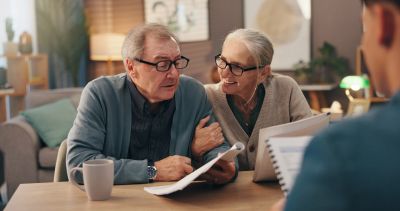 Elderly couple reviewing documents together.