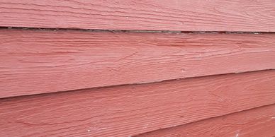 Close-up of red wooden siding on a building.