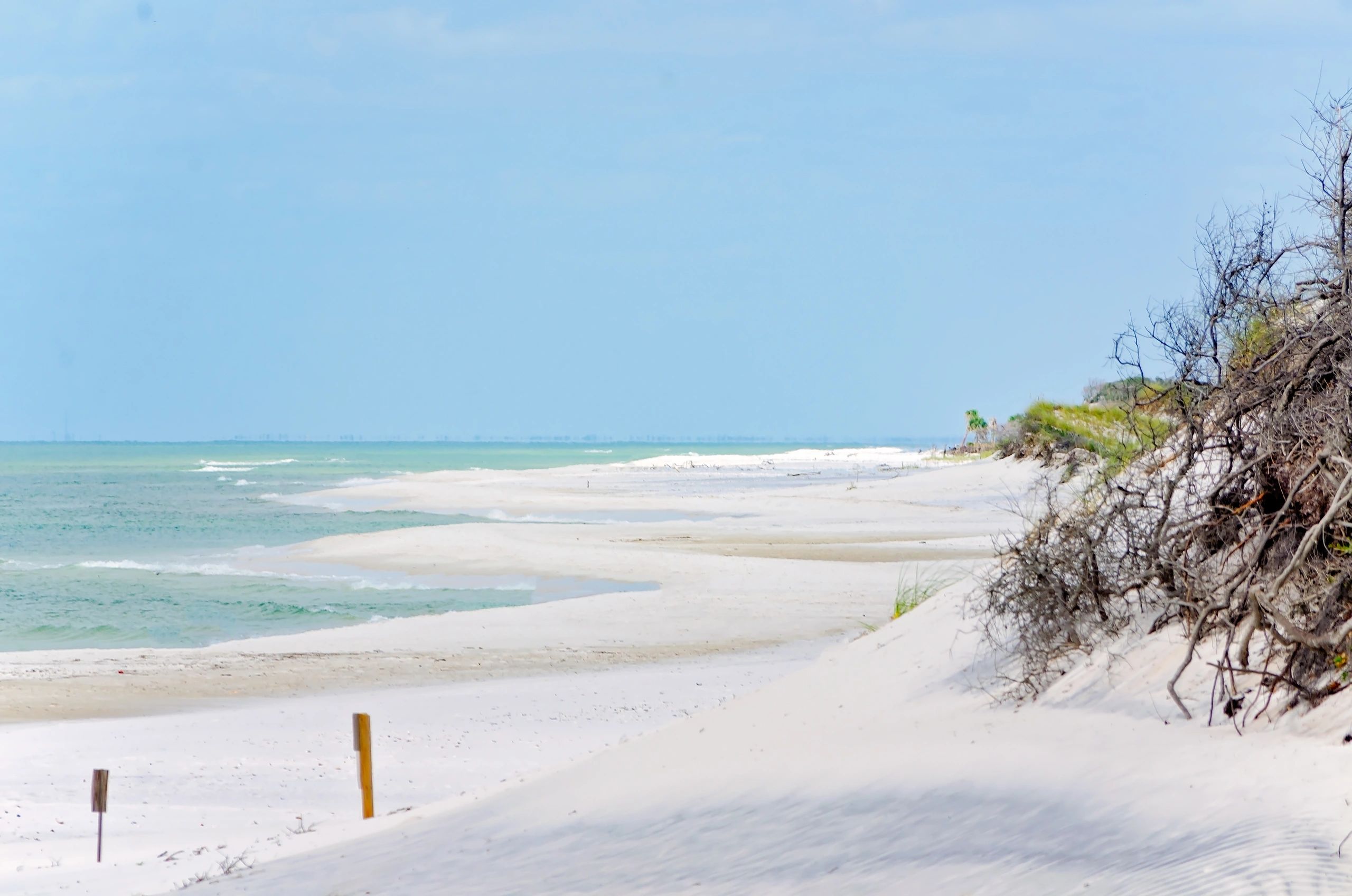 Serene beach with white sand and clear water.