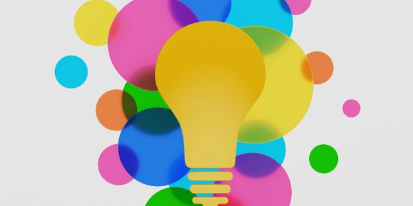 Colorful overlapping circles surrounding a yellow light bulb icon.