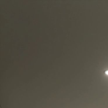 Dark ceiling with a single bright light on the right.