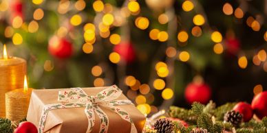 Christmas gift with festive lights and decorations.