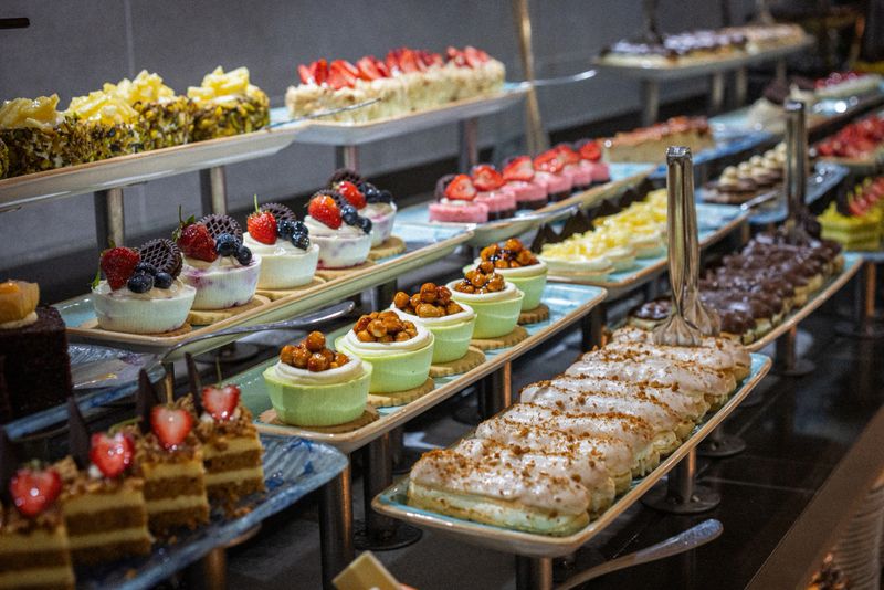 Various cakes and puddings displayed in a hotel buffet - Dessert selection