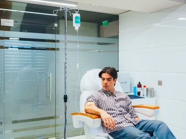 Man receiving intravenous vitamin therapy in beauty clinic