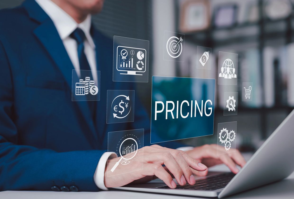 Businessman working on pricing strategy with digital financial icons on laptop.